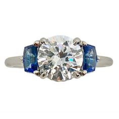 Bringing art deco to the modern world, this stunning mounting features Cadillac cut sapphires and hidden diamond halos.Clearance Item. All Sales Final. Clearance items are not eligible for return.- PRICE IS FOR THE MOUNTING ONLY AND DOES NOT INCLUDE THE CENTER STONE.- PLATINUM.- BLUE SAPPHIRES.- SAPPHIRE WEIGHT: 0.65 CT.- FOR CENTER STONE SIZE: 1.50 CT - 7.5 MM ROUND - SETTING DIAMOND WEIGHT: 0.10 CTW.- FINGER SIZE: 6.5.- Please call one of our Diamond Specialists to help you choose the perfect Diamond And Sapphire Ring, Estate Diamond Jewelry, Semi Mount Ring, S Ring, Retro Jewelry, Hidden Halo, Say Yes, Halo Diamond, Diamond Rings