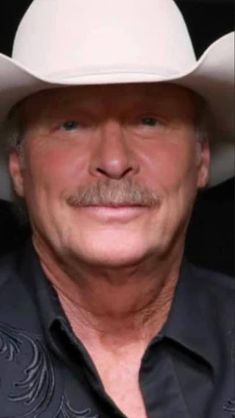 a close up of a person wearing a cowboy hat