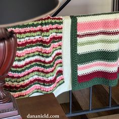 Holly Berry Seashore Christmas Crochet Baby Blanket: Crochet a baby blanket for a little one with a due date around Christmas! This Christmas crochet baby blanket pattern is full of fun, textured stitches, and YES: you can easily memorize this pattern! This Christmas crochet baby blanket pattern is a four-row repeat, but don't let that intimidate you if you're used to simpler designs. Two of the four rows in the repeat are comprised entirely of half double crochets in the back loop only across. I called this baby blanket Holly Berry Seashore because the two remaining rows feature puff stitches that remind me of holly berries, and shell stitches which remind me of sea shells! The blanket is finished off with a camel stitch border for a cozy feel. The shell stitches are made from hdcs, and t Christmas Crochet Blanket Patterns, Half Double Crochet Blanket, Double Crochet Blanket, Crochet A Baby Blanket, Rice Stitch, Crochet Baby Blanket Patterns, Christmas Crochet Blanket, Pistachio Color, Crochet Baby Blanket Pattern