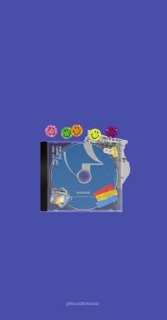 the cd cover is blue and has smiley faces on it, as well as four different colored doughnuts