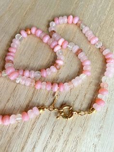 This beautiful pink gemstone necklace makes a perfect gift! Each bead is hand knotted onto silk thread, which gives the necklace a lovely drape.Necklace is 21 inches long, hand knotted with white silk string, gold filled beads, and has gold filled clasp. This is a stunning necklace that completes any outfit. This necklace is a perfect gift!   GEMSTONES  Pink Opal (dyed) Sunstone Rose Quartz Aquamarine Gold Filled Findings BENEFITS OF A HAND KNOTTED NECKLACE 1. A knotted necklace is safe and secu Luxury Hand-knotted Beaded Necklaces As Gift, Adjustable Rose Quartz Round Bead Necklace, Adjustable Rose Quartz Necklace With Round Beads, Single Strand Pink Opal Necklace With Round Beads, Pink Spiritual Necklace With Faceted Beads, Adjustable Rose Quartz Gemstone Necklace, Pink Beaded Necklace With Round Beads For Gifts, Pink Round Bead Necklace For Gifts, Pink Round Beads Necklace For Gifts