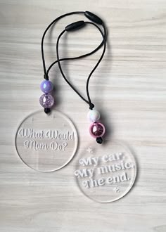 two necklaces that say, what would mom do? and are on a table