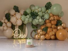 balloons and greenery are displayed on the table