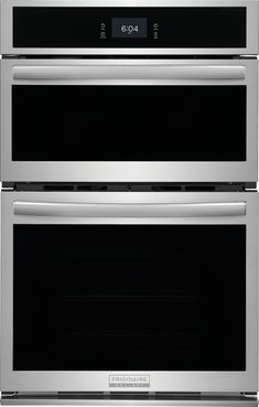 two ovens side by side with the door open