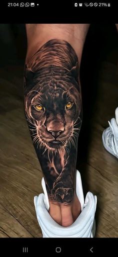 a man's leg with a tiger tattoo on it