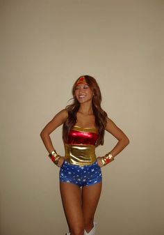 a woman dressed as wonder from the dc comics posing for a photo with her hands on her hips