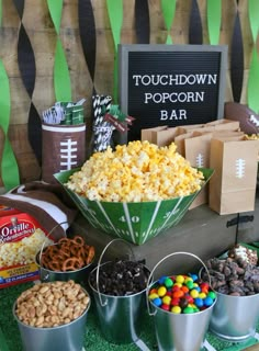 a football themed party with popcorn, candy and snacks on the sidelines is shown