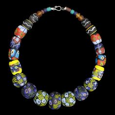 A large necklace comprising of glass bead replicas from Eidem, Norway. Wear as a standalone necklace, or attach between tortoise brooches. For Viking men or women. Total length: approx 50cm (19.7 inch). Beads range from 5mm - 30mm (0.2 - 1.2 inch) wide. Metal clasp for easy closure. Hand-painted & plain glass replica beads from 9th - 10th century Norway. Total weight approx. 302g (10.65oz) approx. Last image shows the original necklace from the museum of Norway. Artisan Glass Necklaces With Oval Beads, Artisan Glass Jewelry With Large Beads, Traditional Single Strand Glass Jewelry, Artisan Glass Bead Necklaces, Artisan Glass Beaded Necklaces, Artisan Glass Necklaces With Round Beads, Glass Necklace With Large Round Beads, Unique Glass Necklaces With Polished Beads, Unique Glass Jewelry With Oval Beads