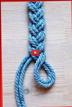 a close up of a blue rope on a wooden surface with a red frame around it