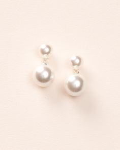 Our Nadine Pearl Dangle Earrings are simple & chic. Add a touch of elegance to any look with these earrings designed with small lustrous off white pearls accented with a larger pearl dangle. Off white, glass pearls 0.75" length Hypoallergenic, lead-free & nickel-free Earrings will match with both ivory and white gowns Style #4455 Pearl White Pearl Earrings, Cream Pearl Drop Jewelry, Delicate White Bridal Earrings With Pearl Charm, White Pearl Embellished Earrings For Formal Occasions, Elegant Cream Earrings For Formal Occasions, White Pearl Button Jewelry For Party, White Jewelry With Pearl Buttons For Parties, Elegant White Pearl Embellished Earrings, Elegant Cream Dangle Earrings