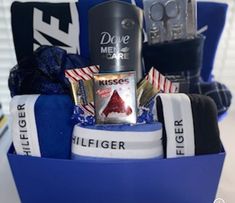 a blue basket filled with assorted items on top of a table