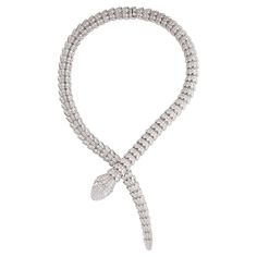 Bulgari Serpenti diamond snake necklace in 18k white gold, accompanied by Bulgari box. This striking Bulgari Serpenti piece features approximately 73.81 carats of round brilliant cut diamonds pave set over the entirety of the necklace, as well as 2 pear shape diamond eyes weighing approximately 1.00 carat. Total, there is approximately 74.81 carats. Numbered and signed BVLGARI. Bulgari Serpenti Viper Necklace, Snake Necklace Bulgari, Bulgari Jewelry Snake, Bvlgari Serpenti Necklace Gold, Snake Diamond Necklace, Bvlgari Jewelry Aesthetic, Bulgari Snake Necklace, Bvlgari Serpentine Necklace, Bvlgari Snake Necklace