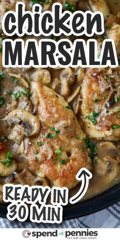 chicken marsala with mushrooms and parsley in a white sauce on a black plate