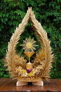 a table topped with a cross and wheat wreath