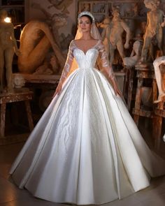 a woman in a white wedding dress posing for the camera