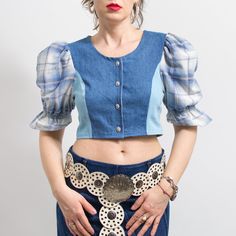 One of a kind handmade bavarian style crop top in blue with plaid puff sleeve top in printed floral pattern - buttoned down at the front - materials: denim, cotton SIZE from the tag: no tag Best fits women: M MEASUREMENTS bust: 36 inches (92 cm) length: 15.5 inches (39 cm) The model is 5'9" (174 cm), measures 35-27-38 (89-69-96 cm) and typically wears clothing in size M Fitted Cotton Crop Top With Puff Sleeves, Trendy Cotton Crop Top With Puff Sleeves, Fitted Denim Blouse With Buttons, Denim Blue Patchwork Tops For Summer, Denim Fitted Blouse With Button Closure, Fitted Denim Blouse With Button Closure, Fitted Short Sleeve Denim Top For Fall, Trendy Fitted Short Sleeve Denim Top, Fitted Cotton Crop Top For Fall