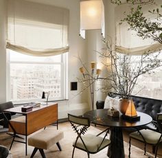 a living room filled with furniture next to a window covered in curtains and windowsills