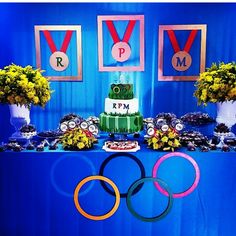 a table topped with a cake and olympic rings