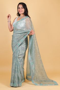 Indulge in luxury with our Net Saree in a stunning blue color, featuring intricate print, swarovski, and sequin work. This exquisite piece exudes elegance and exclusivity, perfect for special occasions. Elevate your style with the finest craftsmanship and design. Net saree with print, swarosvki and sequin work - blue color Saree comes with a blouse piece. Fall and pico done. Fully stitched blouse shown in pictures is optional and can be purchased seperately from our blouses and croptops section. For saree video please connect with us on whatsapp @469-937-0606 Ready to be shipped in USA from San Diego, California. All pictures are original pictures. Colors may slightly vary due to pic resolution. Formal Organza Pre-draped Saree For Diwali, Designer Blue Tissue Silk Pre-draped Saree, Blue Tissue Silk Pre-draped Saree For Designer Wear, Blue Tissue Silk Pre-draped Designer Saree, Elegant Organza Pre-draped Saree With Mirror Work, Elegant Formal Art Silk Pre-draped Saree, Blue Zari Work Party Wear Pre-draped Saree, Elegant Blue Chanderi Pre-draped Saree, Blue Bollywood Style Pre-draped Tissue Silk Saree