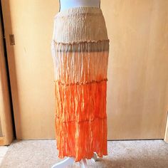 Nwt Sz S Gradient Boho Skirt For Essentials By Milano. The Material Is Crimped, Like An Accordian Fold. It Is Tie Dyed, Starting With Cream/Beige On Top And Darkening To Cream/Orange On The Bottom. Including The Top, It Has Four Tiers. The Skirt Is A Pull On With A Comfortable Elastic Waistband. It Is Unlined And Semi Sheer. Measurements Are 24-28 Inches Around The Waist, 38 Inches Free At The Hips, And 34 Inches Long. Orange Maxi Skirt For Spring Beach Outing, Orange Maxi Skirt For Spring Beach Occasion, Orange Maxi Skirt For Spring Beach, Orange Lined Skirt For Vacation, Fitted Orange Vacation Skirt, Fitted Orange Skirt For Vacation, Vacation Orange Lined Skirt, Orange Relaxed Fit Lined Maxi Skirt, Flowy Beach Skirt In Orange