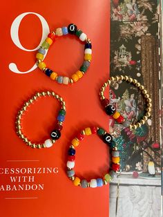 This set of 8 Ball colorful bracelets is crafted with precision, featuring 6mm gold plated beads and vibrant colored glass beads for a unique look. Each bracelet has a different color combination, so you can mix and match to create your own custom style.