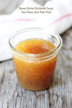 a jar filled with liquid sitting on top of a wooden table