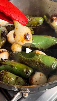 vegetables being cooked in a pan on the stove