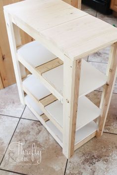 a wooden table sitting on top of a tiled floor