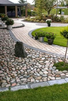 a stone path in the middle of a garden