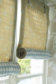 two curtains hanging from the side of a window with blue and white polka dots on them