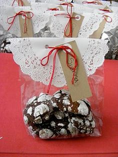 chocolate covered cookies wrapped in cellophane and tied with twine on red table cloth