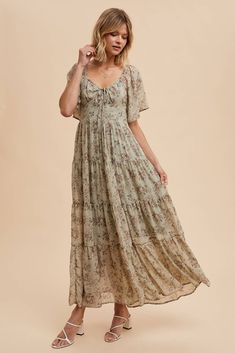 Get ready to turn heads at any wedding with our Isn't It Romantic Floral Dress! With its feminine and sweet design, this dress is the perfect choice for any fall wedding. Don't miss out on the opportunity to be the best-dressed guest! Color: Sage Floral maxi dress Sweetheart neckline Decorative tie front Flutter sleeves Fully lined 100% polyester Bohemian Floral Print Dress With Sweetheart Neckline, Bohemian Floral Dress With Sweetheart Neckline, Bohemian Dress With Floral Print And Sweetheart Neckline, Tiered Maxi Dress With Fitted Bodice For Wedding, Tiered Dress With Fitted Bodice For Garden Party, Fitted Tiered Maxi Dress For Wedding, Garden Party Dress With Fitted Bodice And Tiered Shape, Garden Party Tiered Dress With Fitted Bodice, Flowy Empire Waist Bridesmaid Dress