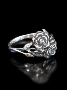 This beautiful and detailed Rose Ring is cast in solid sterling silver.  Two roses entwine and the leaves form the band of the ring. Indulge yourself or someone special in this sparkling bouquet.We have many ring sizes immediately available. We will contact you to let you know if we have your chosen ring size in stock or when to expect shipment.All Marty Magic Jewelry is packaged in a beautiful box embossed with the gold foil Marty Magic dragon logo. Perfect for any occasion.Designed in Californ Rose Jewelry Flower, Dragon Logo, Magic Jewelry, Magic Dragon, Two Roses, Silver Rose Ring, Silver Flower Ring, Silver Gold Jewelry, Ring Flower