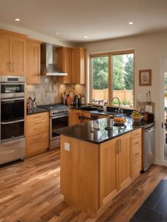 a large kitchen with wooden cabinets and stainless steel appliances, along with hardwood flooring