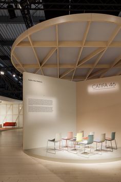 a room with chairs and a sign that says catia 46 on the wall next to it