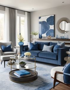 a living room filled with furniture and blue accents in shades of gray, white and gold