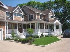 a car is parked in front of a large house with two storyed houses on each side