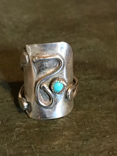 Hand made sterling silver ring with small turquoise stone, stamped sterling on the back. this very unique piece sets nicely on the finger. size 7, found a set of three. which will all be on the site. It measures about 1 inch long and 1/2 inch wide. Southwestern Silver Open Ring Jewelry, Southwestern Style Silver Open Ring Jewelry, Unique Turquoise Ring Jewelry, Unique Open Band Sterling Silver Jewelry, Southwestern Turquoise Ring In Sterling Silver, Turquoise Open Ring Stamped 925, Unique Turquoise Open Ring Stamped 925, Unique Open Turquoise Ring Stamped 925, Artisan Open Ring Jewelry Stamped 925