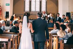 the bride and groom are walking down the aisle