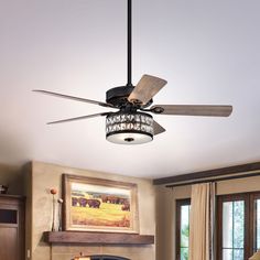 a living room with a fireplace and ceiling fan in the middle of it's center