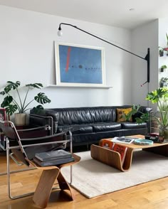 a living room filled with furniture and plants