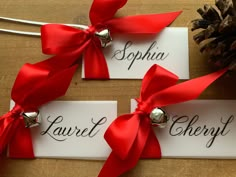 two name tags with bells tied to them