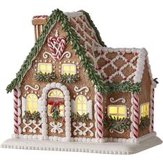 a gingerbread house decorated with candy canes and greenery