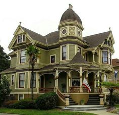 an old victorian style house with a clock on the front