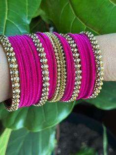 Beautiful hot pink and golden color bangles with stone detailing for a classic look. Made of metal and available in a 2.10 size, these bangles are sure to add a touch of elegance to your ensemble.Features:  - Made of metal( 25 bangles) - hot pink and golden color - Stone detailing - 2.10 size Pink Gold Bangle For Wedding, Elegant Pink Bangle For Festivals, Pink Bollywood Bangle For Festivals, Pink Bollywood Bracelets For Festivals, Adjustable Pink Bracelet For Diwali, Bollywood Style Pink Bangle For Diwali, Traditional Pink Bangle For Party, Pink Wedding Bracelets For Diwali, Pink Festive Party Bangle