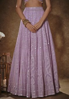 Elevate your wedding guest look with our Lilac Thread work Lehenga Set. Crafted from georgette, this set is a stunning blend of elegance and intricate detailing. The floral lehenga is adorned with exquisite thread and sequins, creating a captivating design that will turn heads. With the added convenience of pockets and cancan, this ensemble combines style and functionality. The matching short-sleeved blouse features a charming bow tie at the front, complemented by cutdana tassels at the hem. Com Thread Work Lehenga, Floral Lehenga, Work Lehenga, Georgette Dupatta, Vacuum Storage, Embroidered Lehenga, Indian Wedding Wear, Lehenga Blouse, Wedding Guest Looks