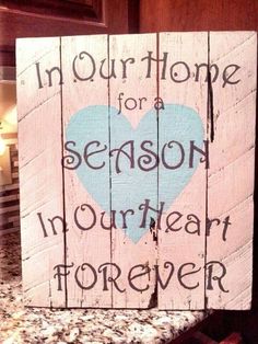 a wooden sign that says, in our home for a season in heart forever