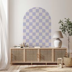 a living room with a large blue and white checkerboard design on the wall