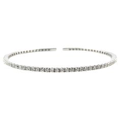 This elegant natural diamond bracelet has the sophisticated look of a bangle with the flexibility of a cuff bracelet! 45 sparkling round brilliant diamonds with a total weight of 1.30 carats are expertly set in this beautifully designed 18k white gold bracelet. Easy to take on and off, this bracelet is perfect for both everyday wear and dressy special occasions! It is a wonderful update on a timeless classic. A natural diamond bracelet is an essential cornerstone in any fine jewelry collection! White Diamond-accented Chain Bracelet, Timeless White Diamond-cut Bracelet, White Gold Diamond Bracelet, Tarnish Resistant, White Gold Diamond Cuff Bracelet - Fine Jewelry, White Gold Diamond Bracelets, Tarnish Resistant, White Gold Bracelet, Ring Pendant Necklace, Tennis Bracelet Diamond, Fine Jewelry Collection