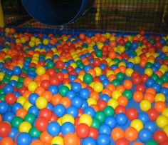 an indoor play area with many balls in it